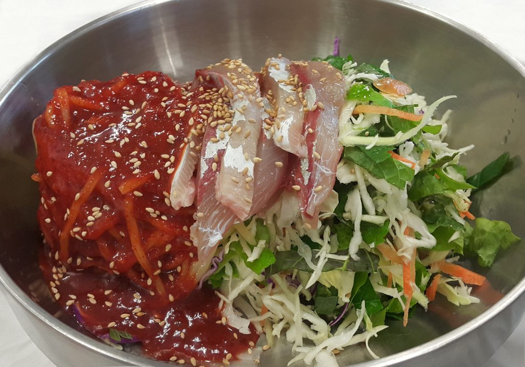 Hoedeopbap raw fish rice bowl with vegetables and red chili sauce