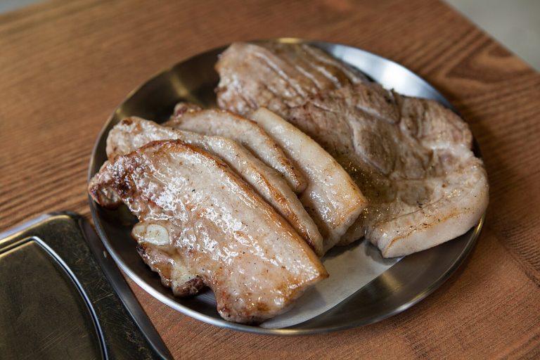Samgyeopsal pork belly grilling at a Korean BBQ table