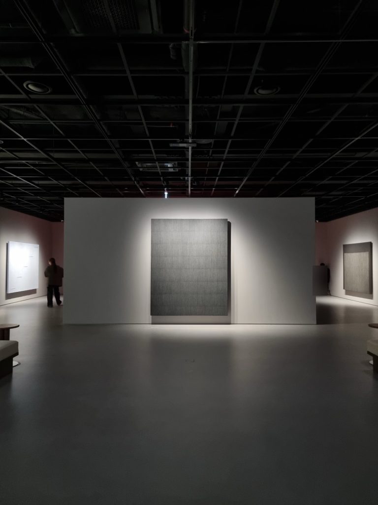 Dark gallery with spotlit large monochrome paintings at Park Seo-Bo Museum