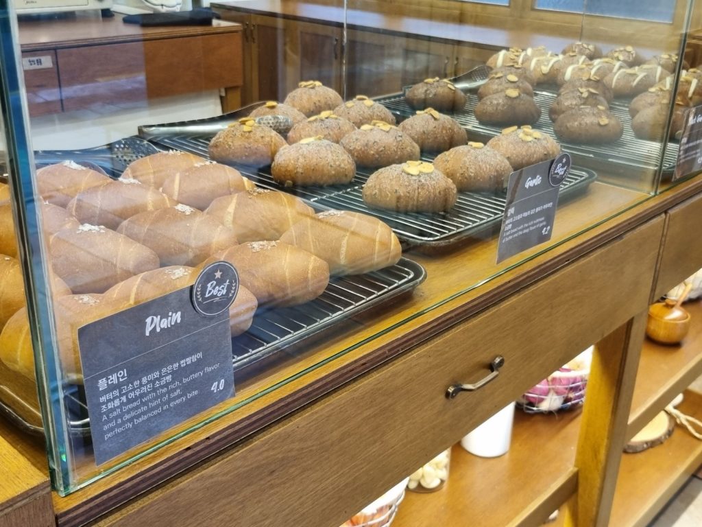 Plain salt bread and garlic salt bread with Best labels in a glass case at Salt Land